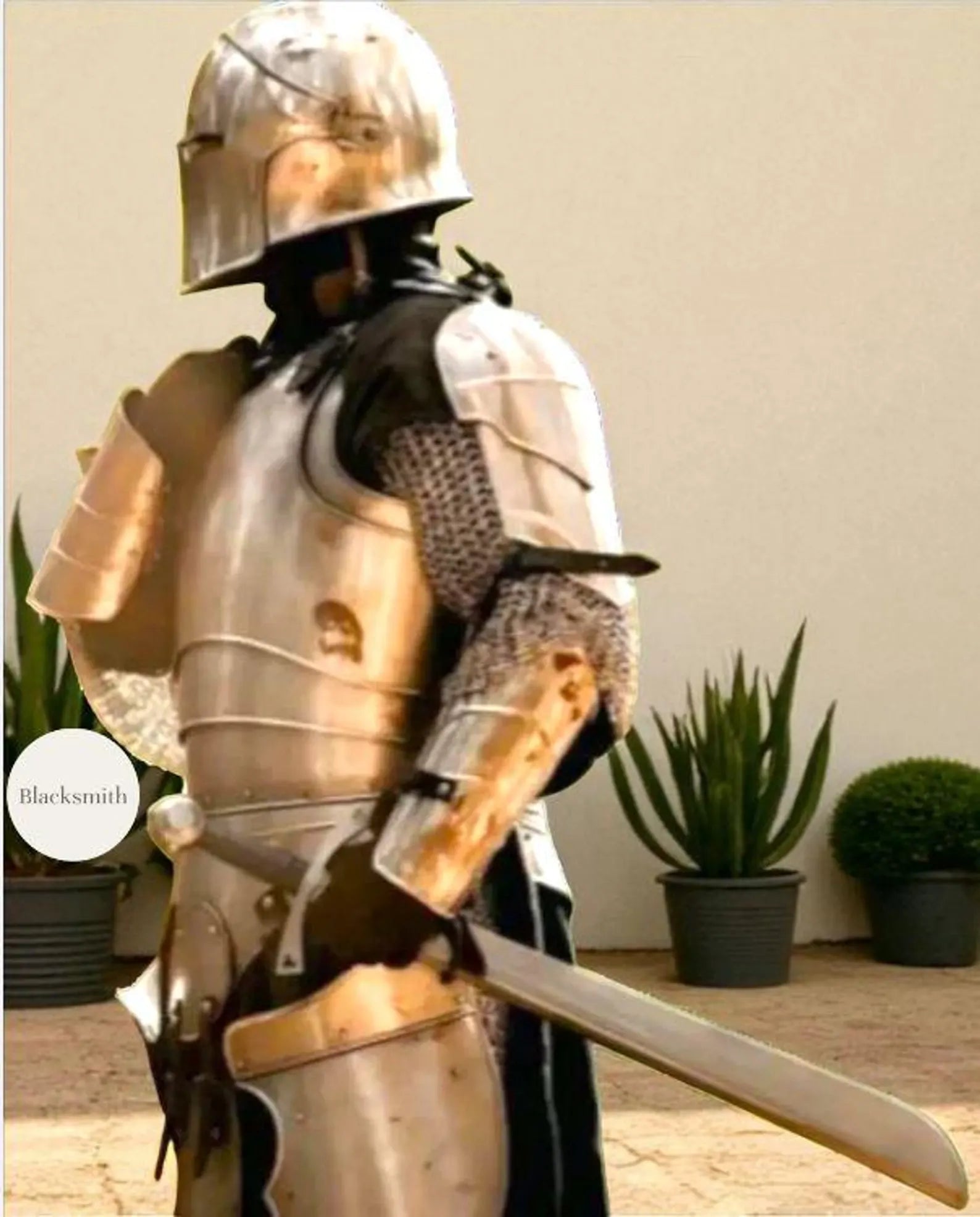 Person wearing a full medieval steel knight armor suit with helmet, holding a sword.