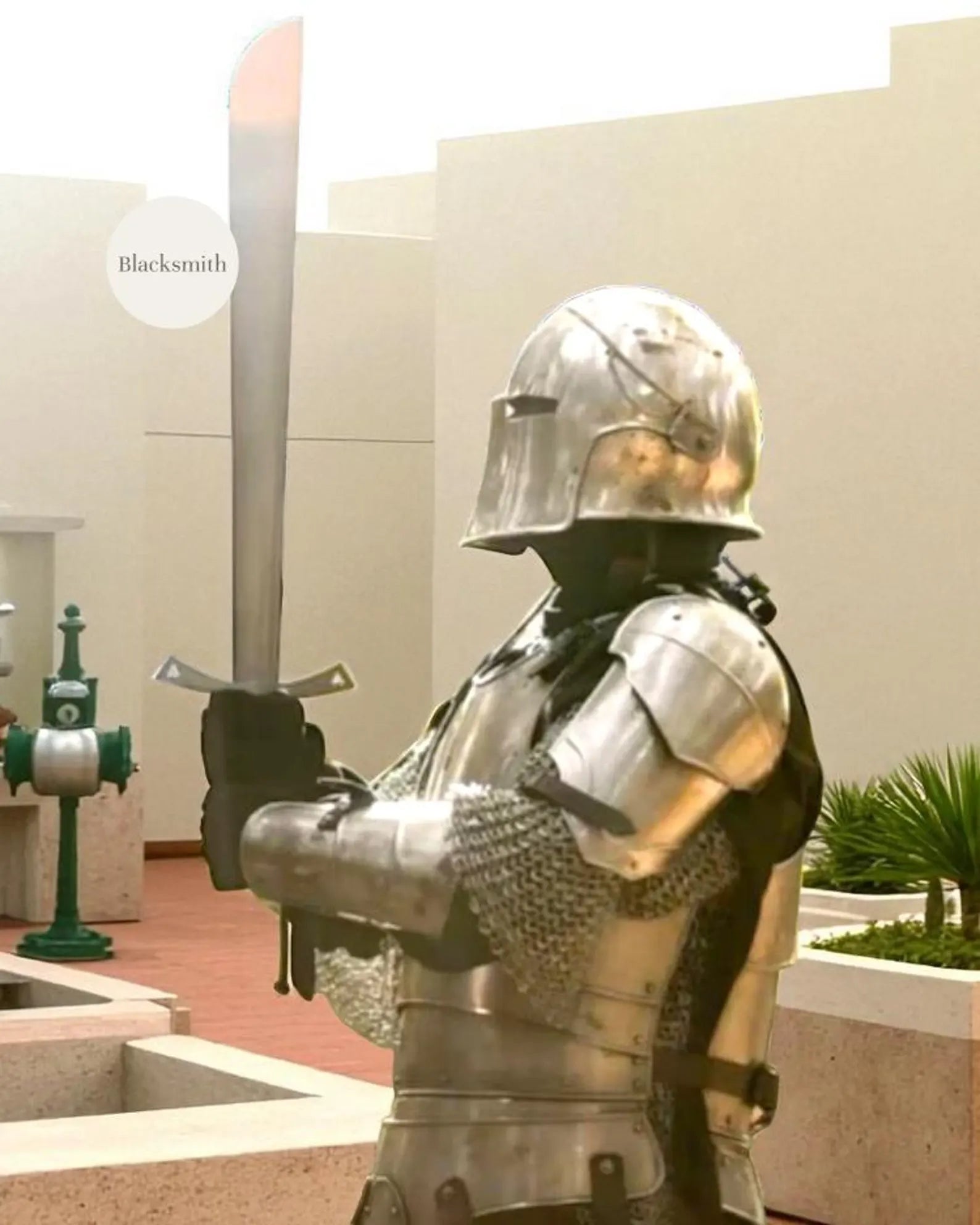 Person wearing a full medieval steel knight armor suit with helmet, holding a sword.