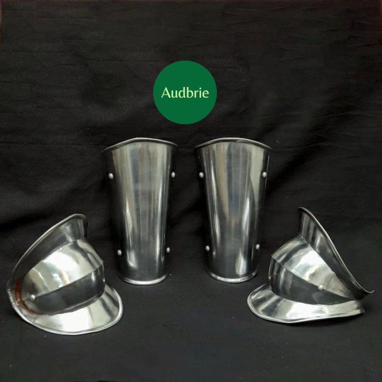 Set of metal armor pieces on a black background with 'Audbrie' branding.