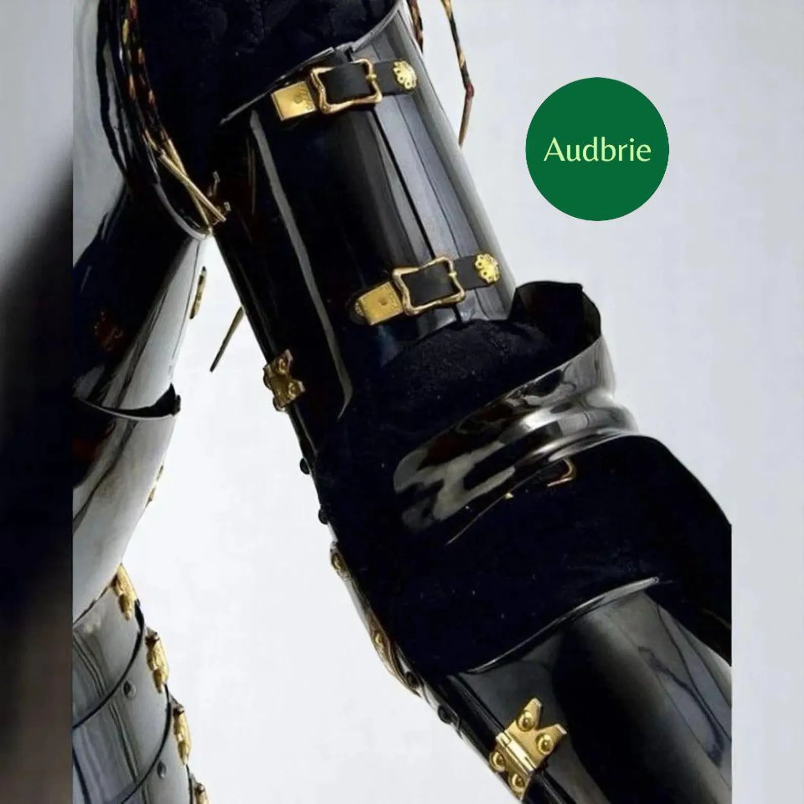 Black clarinet with gold accents on a white background, featuring the brand 'Audbrie'.