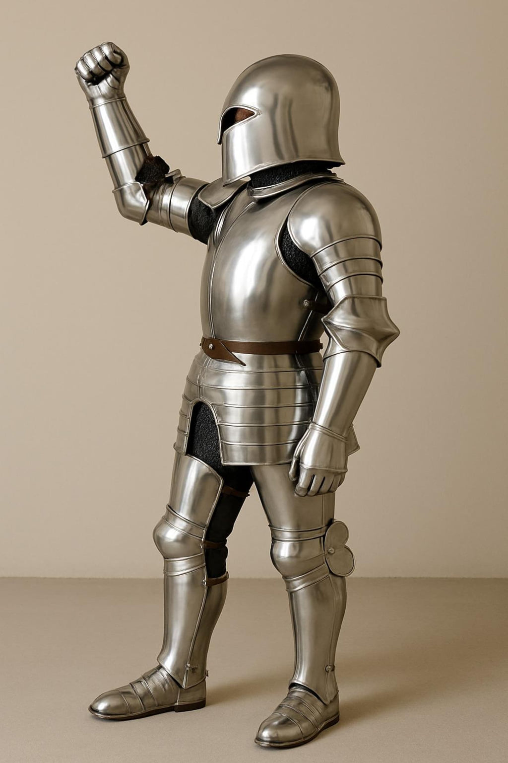 Medieval full plate armor suit with a closed steel helmet, raised arm pose, and polished metal body plates.