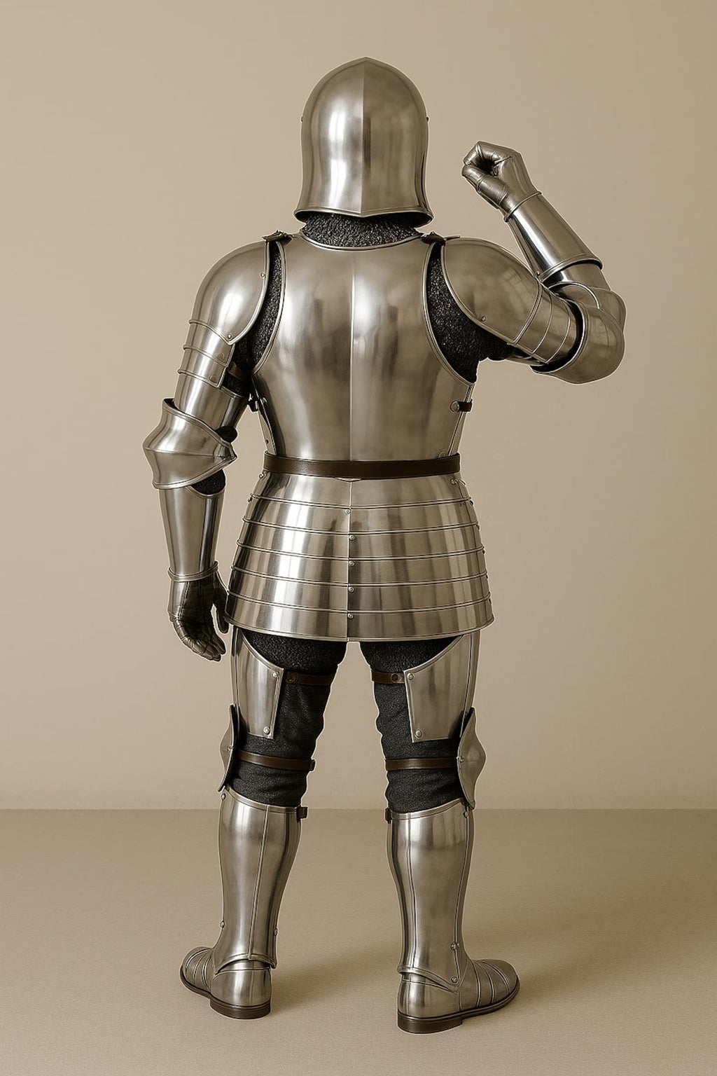 Person wearing full medieval armor against a beige background